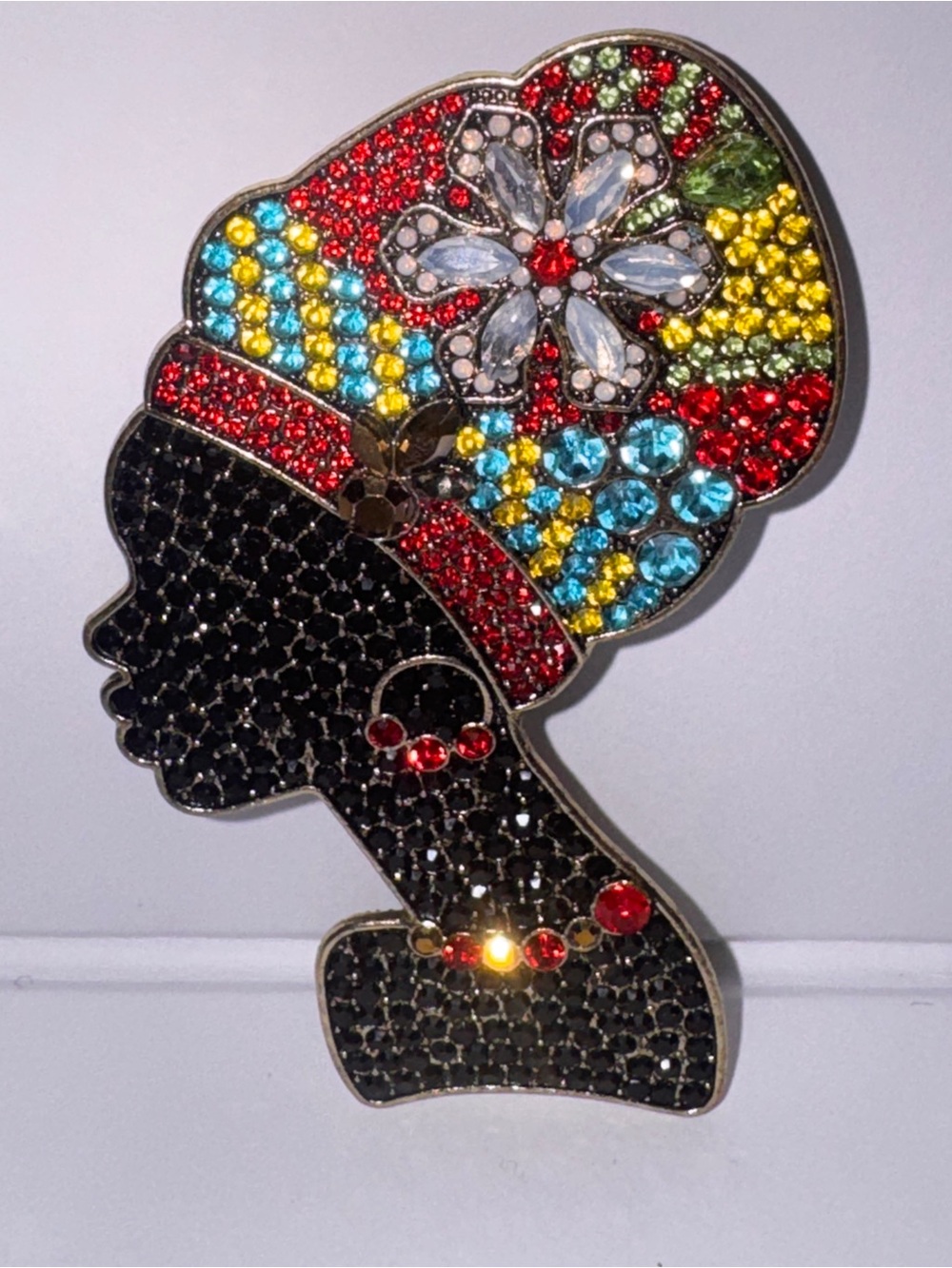 This is a Metal Gallery African American Feminine Silhouette Rhinestone Brooch